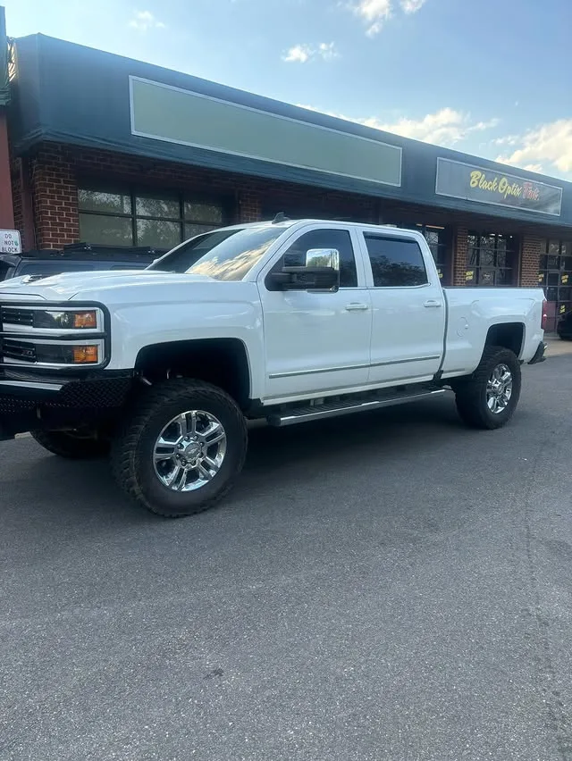 Lifted Chevy Silverado outside Black Optix Tint Short Pump